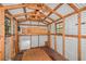 Spacious workshop with wooden beams and ample storage at 21174 Sw Peach Blossom St, Dunnellon, FL 34431