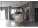 Modern kitchen featuring white cabinets, an island, and gray flooring at 227 Oak Lane Cir, Ocala, FL 34472