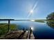 Peaceful lake view from a wooden dock with seating at 45202 Nfs Rd 572-B, Altoona, FL 32702