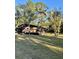 Cabin exterior with a deck, surrounded by trees at 45202 Nfs Rd 572-B, Altoona, FL 32702