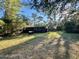 Rustic cabin nestled in a wooded area with ample lawn space at 45202 Nfs Rd 572-B, Altoona, FL 32702