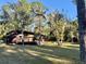 Rustic cabin nestled in a wooded area with ample lawn space at 45202 Nfs Rd 572-B, Altoona, FL 32702