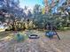 Firepit with seating area in a wooded area at 45202 Nfs Rd 572-B, Altoona, FL 32702