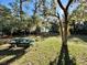 Green picnic table in sunny, grassy backyard at 45202 Nfs Rd 572-B, Altoona, FL 32702