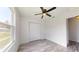 Bedroom with ceiling fan, double door closet, and gray flooring at 4677 Sw 159Th Ct, Ocala, FL 34481