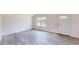 Living room with gray floors and white walls, featuring a door and windows at 4677 Sw 159Th Ct, Ocala, FL 34481