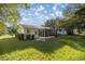 Backyard view of house with screened patio and grass at 6336 Sw 60Th Ave, Ocala, FL 34474