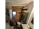 Rustic bathroom with wood-paneled walls and a shower at 14830 Se 61St Street Rd, Ocklawaha, FL 32179