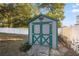 Green storage shed with double doors in backyard at 1520 Ne 39Th St, Ocala, FL 34479