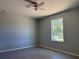 Simple bedroom with window, tile floor, and ceiling fan at 15641 Se 97Th Ave, Summerfield, FL 34491