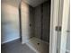 Modern shower with gray tile and a built-in seat at 15641 Se 97Th Ave, Summerfield, FL 34491