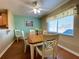 Bright dining room featuring a wood table with six chairs and a large window at 16215 Sw 15Th Ct, Ocala, FL 34473