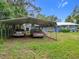 House exterior with carport and landscaped yard at 21500 Sw 33Rd St, Dunnellon, FL 34431