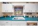 Kitchen with teal countertops and a window overlooking the backyard at 22393 Sw Rainbow Lakes Blvd, Dunnellon, FL 34431