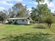 House with a large grassy yard and lush landscaping at 2605 Ne 14Th Ave, Ocala, FL 34470