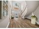Grand entry with hardwood floors, curved staircase, and high ceilings at 2704 Se 31St St, Ocala, FL 34471