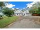 Spacious two-story home with a large driveway and attached three-car garage at 2704 Se 31St St, Ocala, FL 34471