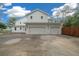 Three-car garage with white exterior and black accents at 2704 Se 31St St, Ocala, FL 34471