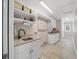 Laundry room with built-in cabinets, sink, and ample counter space at 2704 Se 31St St, Ocala, FL 34471