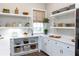 Well-organized pantry with white cabinets and open shelving at 2704 Se 31St St, Ocala, FL 34471