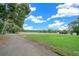 Green pasture with white fence, barn, and trees at 2704 Se 31St St, Ocala, FL 34471
