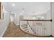 Elegant upper hallway with hardwood floors and a stunning chandelier at 2704 Se 31St St, Ocala, FL 34471