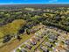 An aerial view of a house situated in a residential area with surrounding greenery at 3853 Se 99Th Ln, Belleview, FL 34420