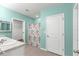 Bathroom with double vanity, shower, and light teal walls at 3853 Se 99Th Ln, Belleview, FL 34420