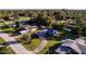 Aerial view of a charming ranch house with a spacious yard and tree-lined neighborhood at 481 Spring Ln, Ocala, FL 34472