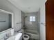 Updated bathroom with marble tile, bathtub, and new fixtures at 481 Spring Ln, Ocala, FL 34472