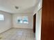 Simple bedroom with tile floors and a large window at 481 Spring Ln, Ocala, FL 34472