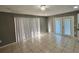 Bright living room with tile floors and double doors to patio at 481 Spring Ln, Ocala, FL 34472