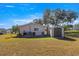 Backyard view of home with shed and grassy area at 6287 Sw 106Th Pl, Ocala, FL 34476