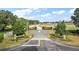 Community entrance with paved road and landscaping at 7403 Ne 22Nd Court Rd, Ocala, FL 34479