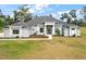 Beautiful two-story home with a large front yard and gray exterior at 7403 Ne 22Nd Court Rd, Ocala, FL 34479