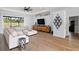 Spacious living room with large sectional sofa and hardwood floors at 7403 Ne 22Nd Court Rd, Ocala, FL 34479