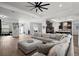 Open living room with sectional sofa and views to kitchen and dining area at 7403 Ne 22Nd Court Rd, Ocala, FL 34479
