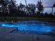 Enclosed pool area with waterfall feature and lighting at 7403 Ne 22Nd Court Rd, Ocala, FL 34479