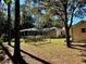 Home's backyard with a screened enclosure and large yard at 7535 Sw 185 Avenue Rd, Dunnellon, FL 34432