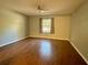 Spacious bedroom with wood laminate flooring and a large window at 7535 Sw 185 Avenue Rd, Dunnellon, FL 34432