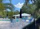 Relaxing pool area with tables, chairs, and umbrellas at 7535 Sw 185 Avenue Rd, Dunnellon, FL 34432