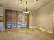 Dining area with tile floor, sliding glass doors to the pool, and chandelier at 7535 Sw 185 Avenue Rd, Dunnellon, FL 34432