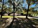Side view of the house, showing a shed and a large yard with trees at 7535 Sw 185 Avenue Rd, Dunnellon, FL 34432
