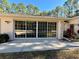 Home exterior showcasing a sliding glass door leading to a patio at 7535 Sw 185 Avenue Rd, Dunnellon, FL 34432