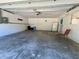 Spacious garage with ample storage shelving and space for a refrigerator at 7535 Sw 185 Avenue Rd, Dunnellon, FL 34432