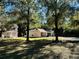 House exterior with a two-car garage and large yard at 7535 Sw 185 Avenue Rd, Dunnellon, FL 34432