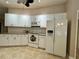Kitchen with white appliances and granite counters at 7535 Sw 185 Avenue Rd, Dunnellon, FL 34432