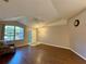 Living room with laminate floors, vaulted ceiling, and a view of the entryway at 7535 Sw 185 Avenue Rd, Dunnellon, FL 34432