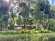 Relaxing pavilion nestled amongst palm trees near the water at 7535 Sw 185 Avenue Rd, Dunnellon, FL 34432