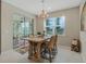 Bright dining area with wooden table and chairs, near sliding glass doors at 8520 Sw 52Nd Lane Rd, Ocala, FL 34481